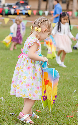 little girl picking up candy on Easter