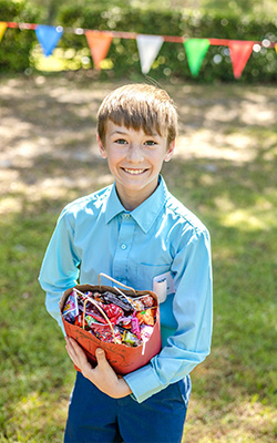 young boy holding a bag full of candy