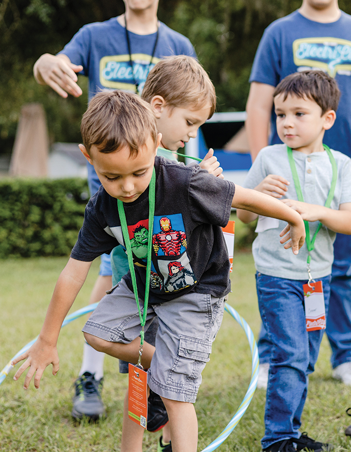 young boy playing a team game outside