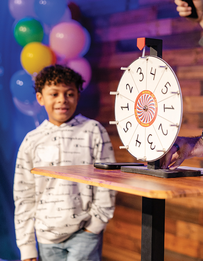 indoor game show boy spinning the wheel